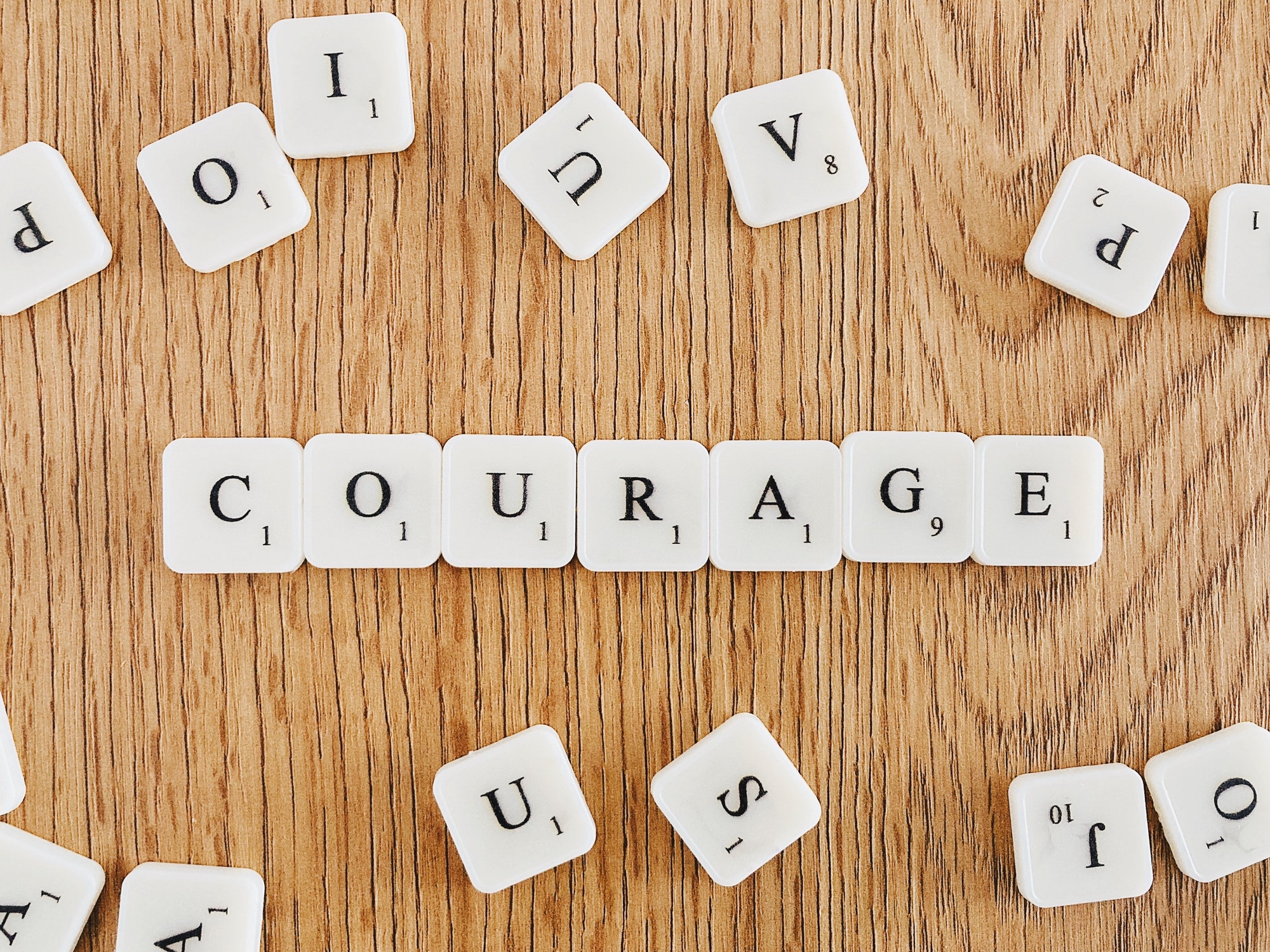 “Courage” written with scrabble tiles