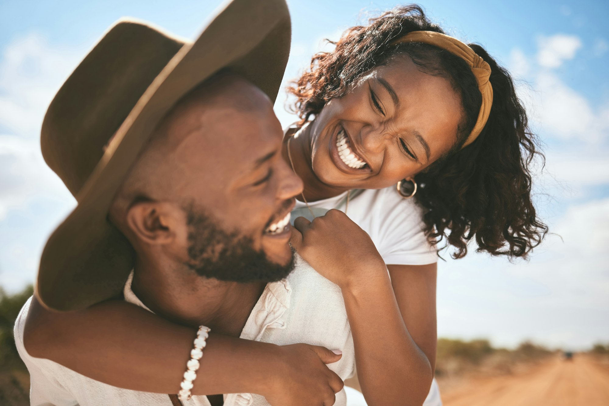 Happy, love and summer hug of a couple together with quality time in nature. Black people with happ